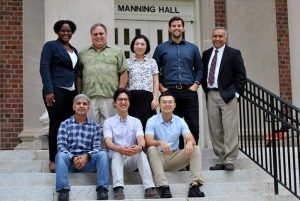 Group picture of CHIP PhD students and faculty on the steps of Manning Hall.