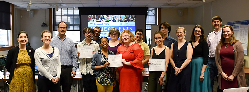 Student participants, project fair winners, faculty, and guests pose together at the end of the event.