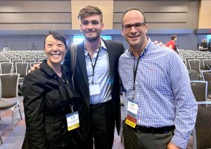 Arlene Chung, Bryce Morrow, and David Gotz pose together at the IEEE VIS Conference.