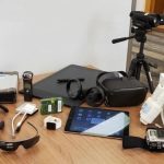Collection of tech equipment including voice recorder, iPad, digital cameras, Wii, and VR set